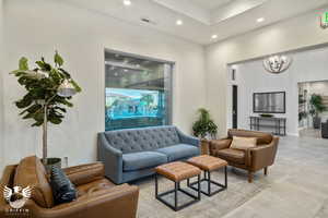 Tiled living room featuring an inviting chandelier