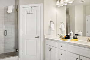 Bathroom with walk in shower and double sink vanity