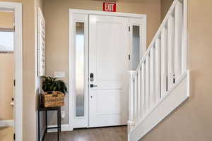 Foyer entrance with hardwood / wood-style flooring