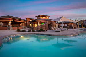 Pool at dusk featuring a patio area and a gazebo