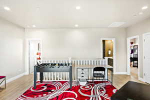 Bedroom featuring light hardwood / wood-style floors and ensuite bathroom