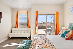 Carpeted bedroom featuring access to outside and multiple windows