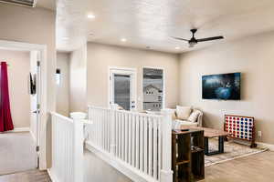 Interior space featuring a textured ceiling and ceiling fan