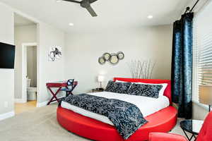 Bedroom featuring light hardwood / wood-style floors, connected bathroom, and ceiling fan