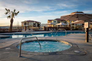 View of swimming pool with a community hot tub