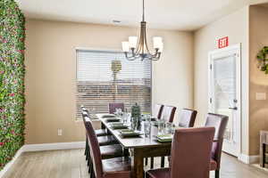 Dining space with a chandelier and light wood-type flooring