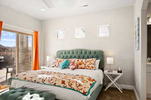 Carpeted bedroom with multiple windows and ceiling fan