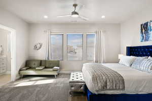 Bedroom featuring ensuite bath, carpet, and ceiling fan