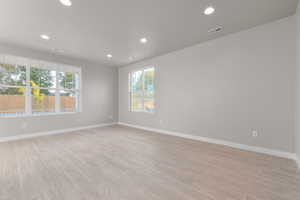 Empty room with light hardwood / wood-style floors