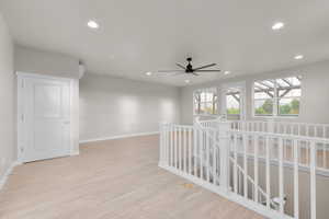 Hallway with light hardwood / wood-style flooring