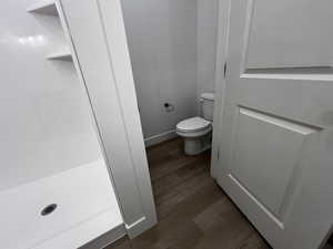 Bathroom featuring toilet and wood-type flooring