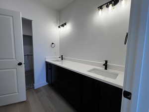 Bathroom featuring wood-type flooring and double sink vanity