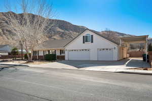 View of front facade with a garage and a mountain view