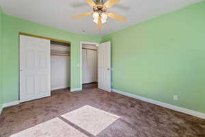 Unfurnished bedroom with ceiling fan, carpet floors, and a closet