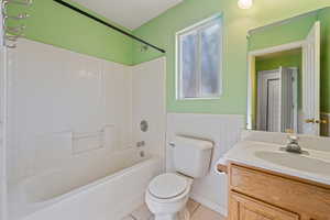 Full bathroom with tile patterned floors, toilet, shower / bathing tub combination, and vanity