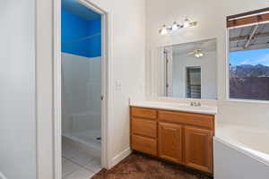 Bathroom featuring vanity, tile patterned floors, plus walk in shower, and ceiling fan