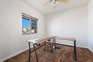 Office area featuring ceiling fan and carpet flooring