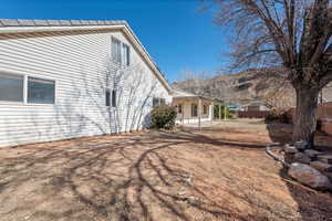 View of property exterior featuring a mountain view and a patio area