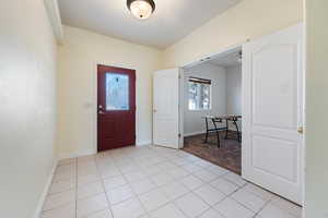 Foyer entrance featuring light tile patterned flooring