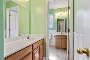 Bathroom with tile patterned floors, toilet, and vanity