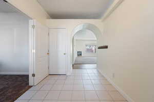 Hall featuring light tile patterned floors