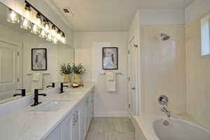 Private Master Bathroom with double sink, quartz countertops, shower & deep soaker tub with private toilet