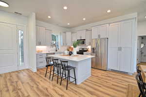 New White Quartz Countertops with a sink window over looking the front yard