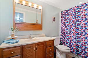 Basement bathroom featuring large vanity, and tub/shower combination.