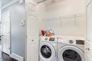 Laundry space featuring storage shelf, and hardwood  flooring.