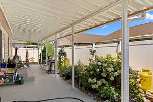 Low maintenance, worry-free backyard space with covered patio and epoxy finish.