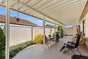 Low maintenance, worry-free backyard space with covered patio and epoxy finish.