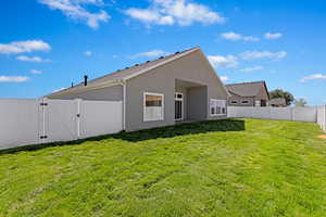 Rear view of property featuring a lawn