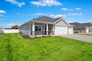 View of front of property featuring a garage, a front lawn, and central air condition unit