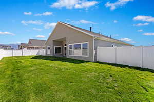 Rear view of property featuring a lawn