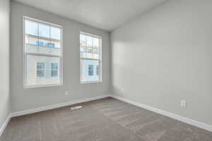 Unfurnished room with carpet