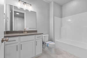 Full bathroom featuring vanity, toilet, and tub / shower combination