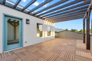 Wooden terrace featuring a mountain view and a pergola