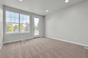 Spare room with light colored carpet