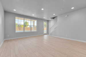 Unfurnished room featuring a healthy amount of sunlight and light wood-type flooring