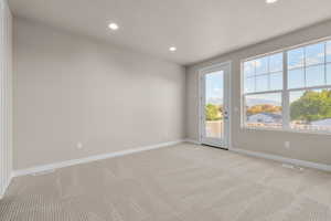 Carpeted empty room with a textured ceiling