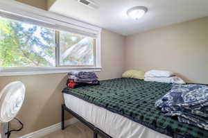 Carpeted bedroom with a textured ceiling