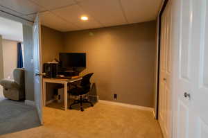 Carpeted office with a drop ceiling