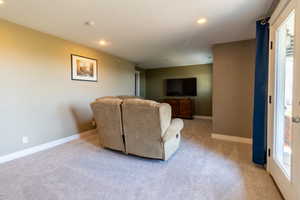 Living room featuring a wealth of natural light and light colored carpet