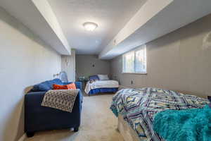 Carpeted bedroom featuring a textured ceiling