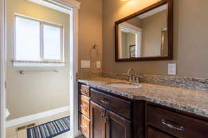 Bathroom featuring tile patterned floors and vanity