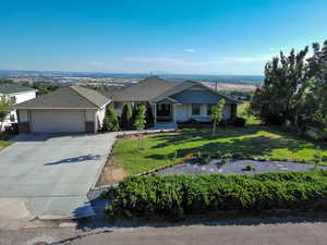 Ranch-style home with a garage and a front lawn