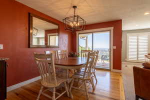 Dining space featuring an inviting chandelier, light hardwood / wood-style flooring, and a healthy amount of sunlight