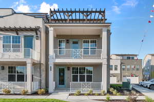 Townhome / multi-family property with a balcony