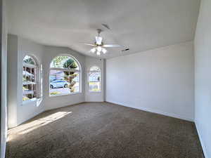 Spare room with ceiling fan and carpet flooring