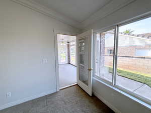 Interior space featuring crown molding, lofted ceiling, carpet, and ceiling fan